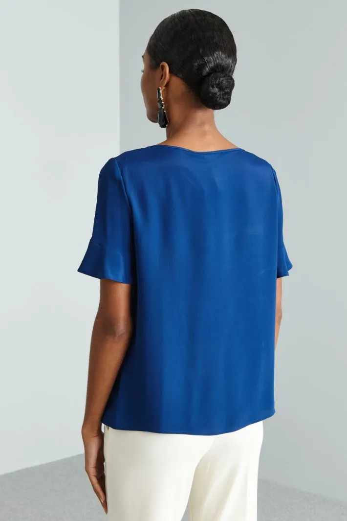 Blusa con pieghe ribattute